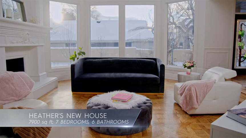 Heather Gay's pink and white living room with text overlaid, "Heather's New House; 7900 sq. ft; 7 bedrooms, 6 bathrooms."