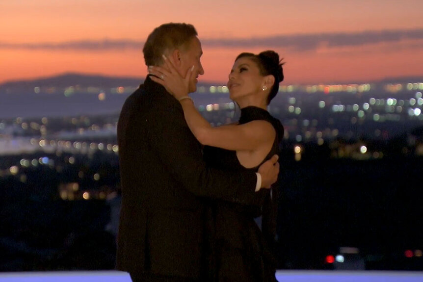 Heather Dubrow and Terri Dubrow embracing and looking at each other while on their deck.