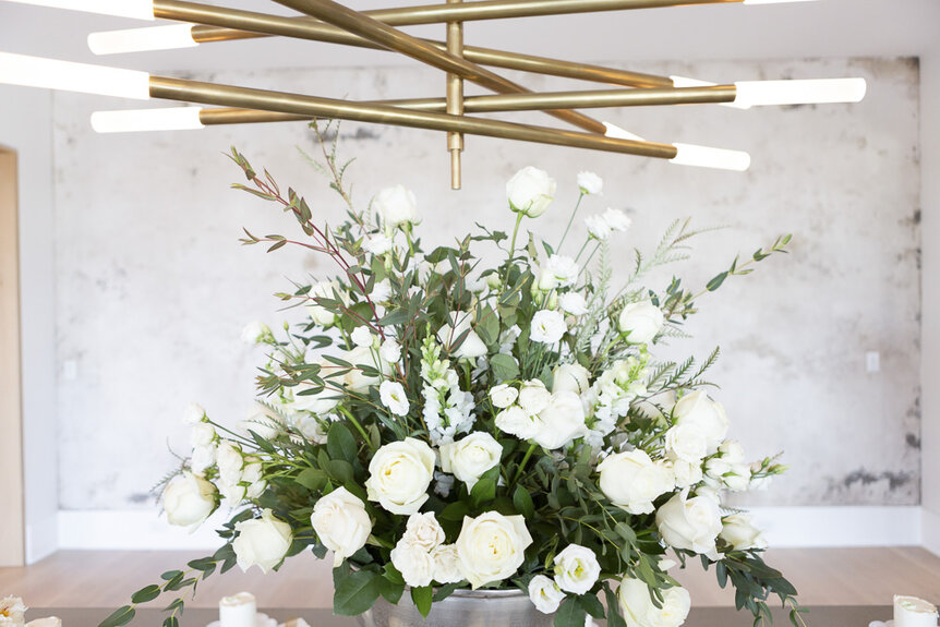 A large, white, floral display at Madison LeCroy and Brett Randle's wedding party in Charleston, South Carolina.