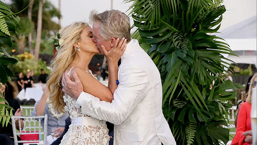 Camille Grammer and David Meyer kissing at the altar in Hawaii at their wedding.