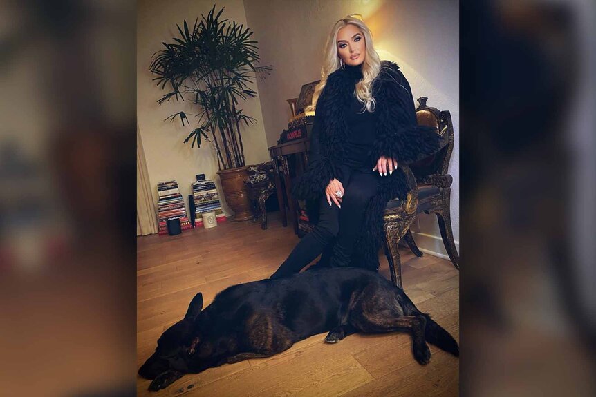 Erika Jayne of The Real Houswives of Beverly Hills sits with her dog, Tiago.
