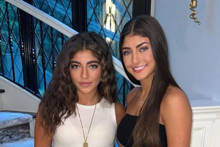 Milania Giudice and Audriana Giudice posing together in casual outfits in front of a window.