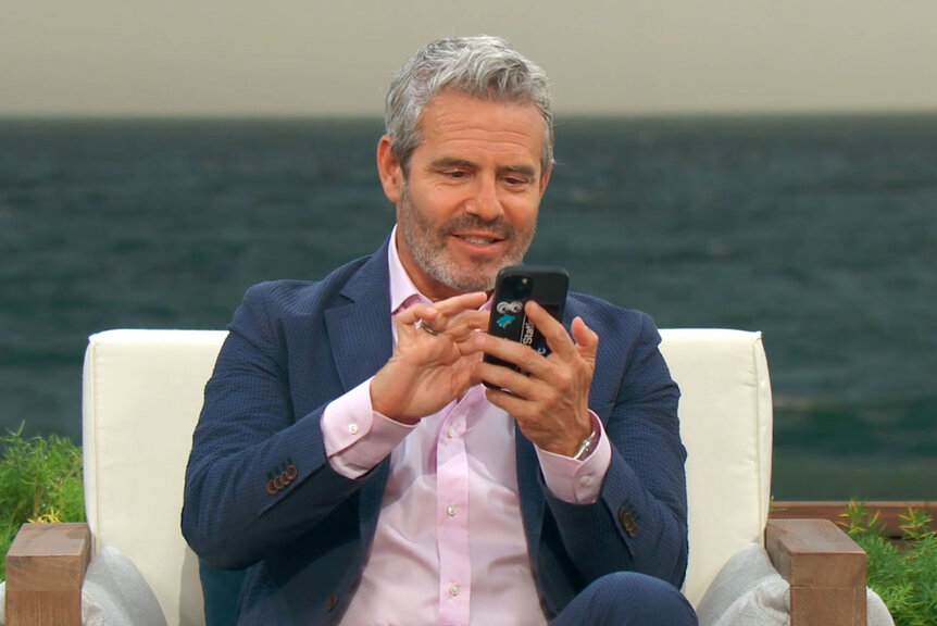 Andy Cohen looks at his phone while on a break at the RHOC reunion.