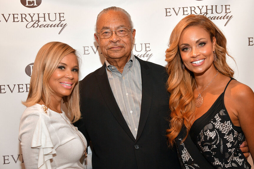 Erika Liles, Gizelle Bryant and her father, Curtis Graves, at an event for Every Hue Beauty.