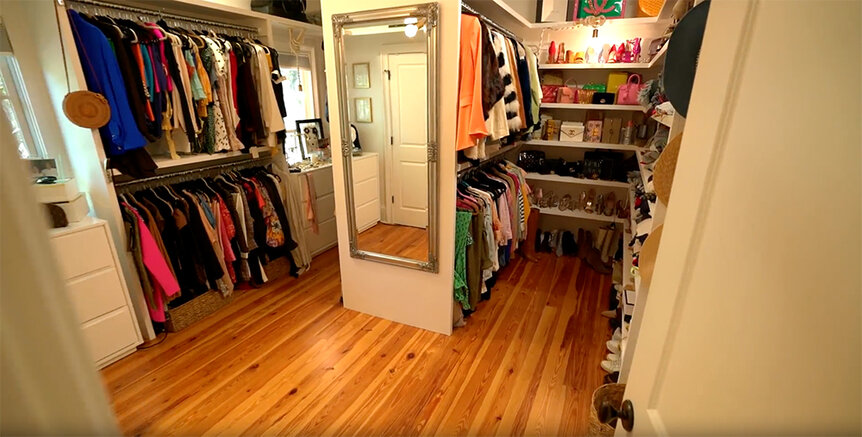 Leva Bonaparte's closet with multiple sections and a floor length mirror.