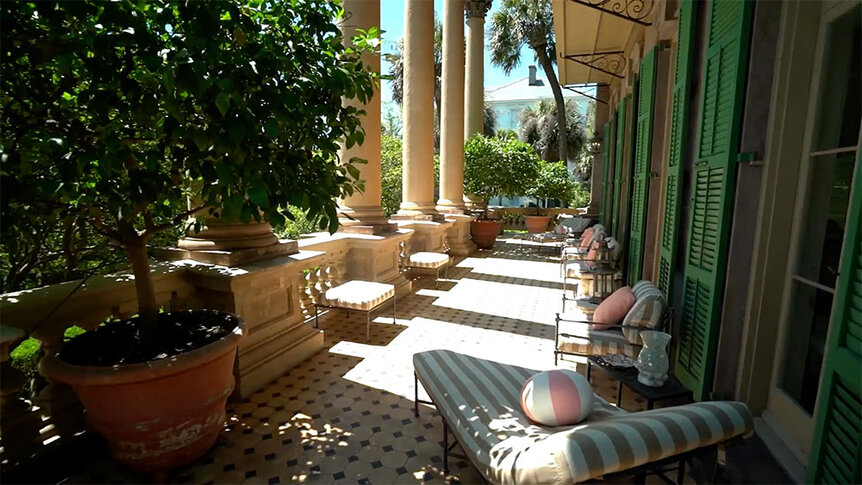 Patricia Altschul's porch with seating, columns, and potted plants.