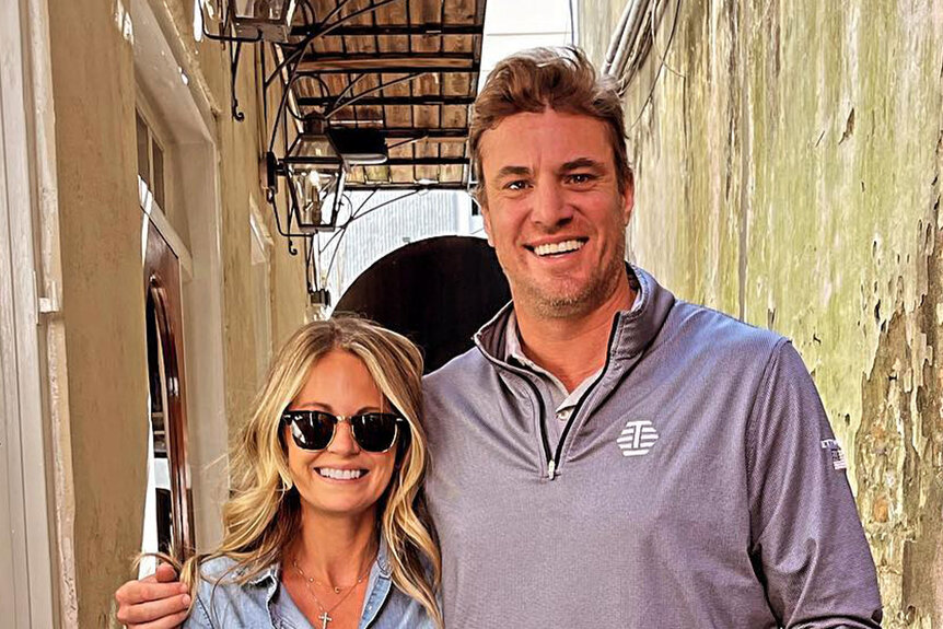 Shep Rose and Cameran Eubanks posing together in casual outfits in an alleyway.