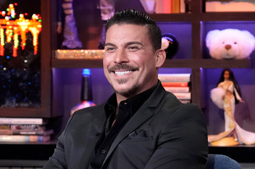 Jax Taylor smiles while seated as a guest on WWHL