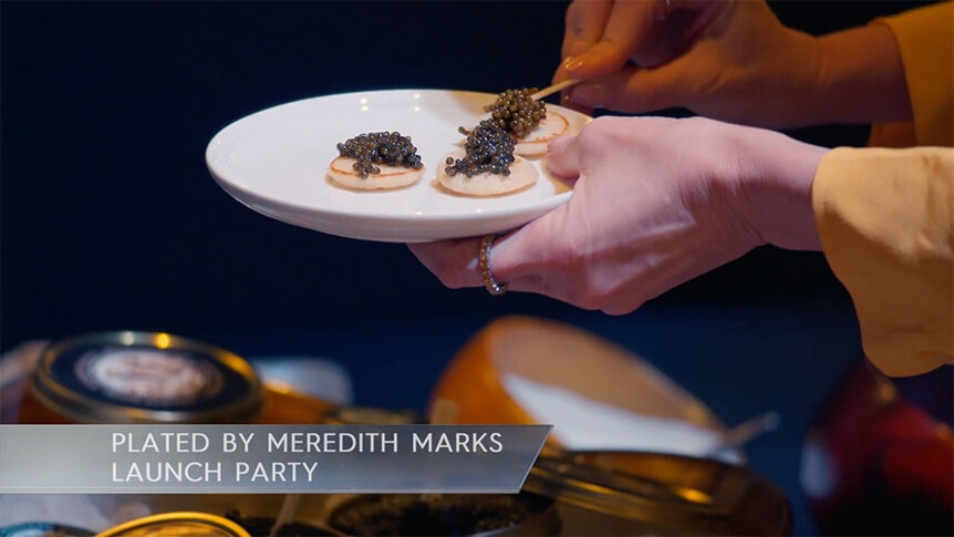 Caviar being plated at Meredith Marks' launch party.