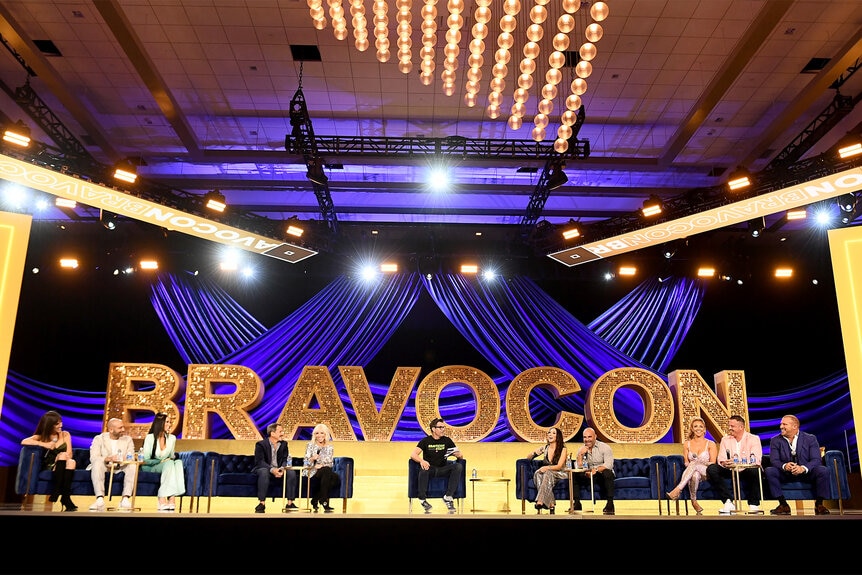 The cast of real house wives of new jersey on stage during a panel at Bravocon 2023
