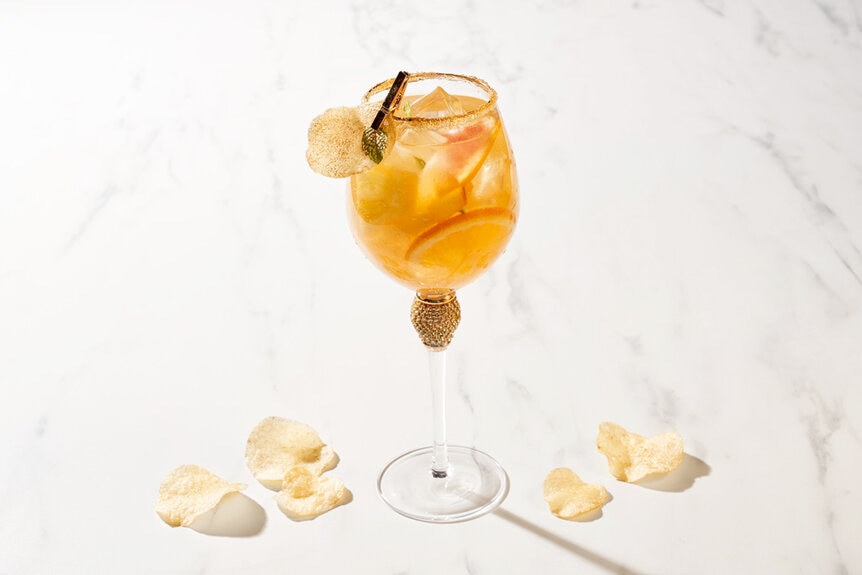 Orange cocktail in a wine glass offered at BravoCon 2023