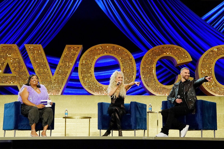 X Mayo, Erika Jayne, and Mikey Minden sit onstage during a panel at BravoCon 2023