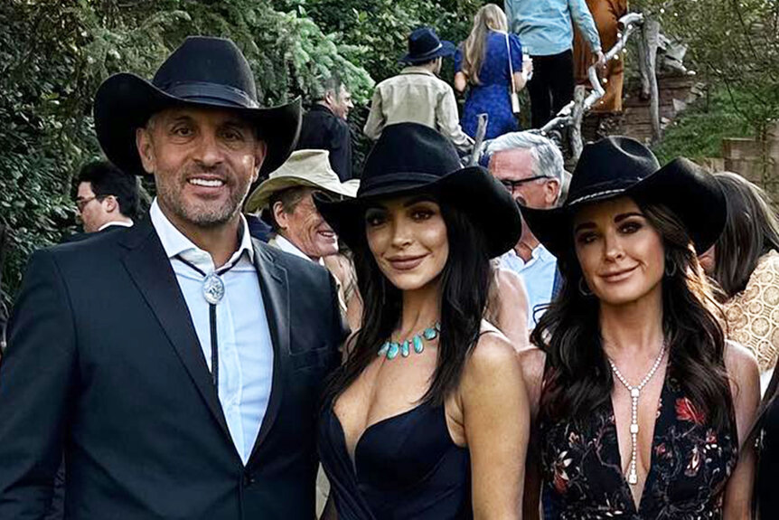 Kyle Richards, Mauricio Umansky, and Farrah Brittany posing together in cowboy hats at a wedding in Aspen, Colorado.