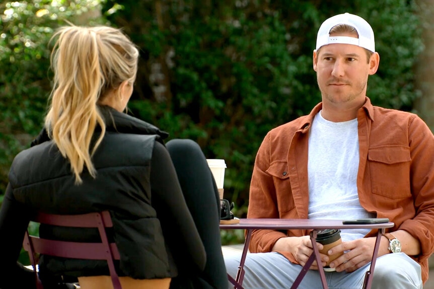 Austen Kroll and Olivia Flowers having a conversation while filming for Southern Charm Season 9.