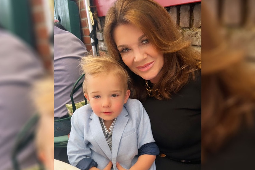 Lisa Vanderpump sits and smiles with her grandson, Theo Sabo.