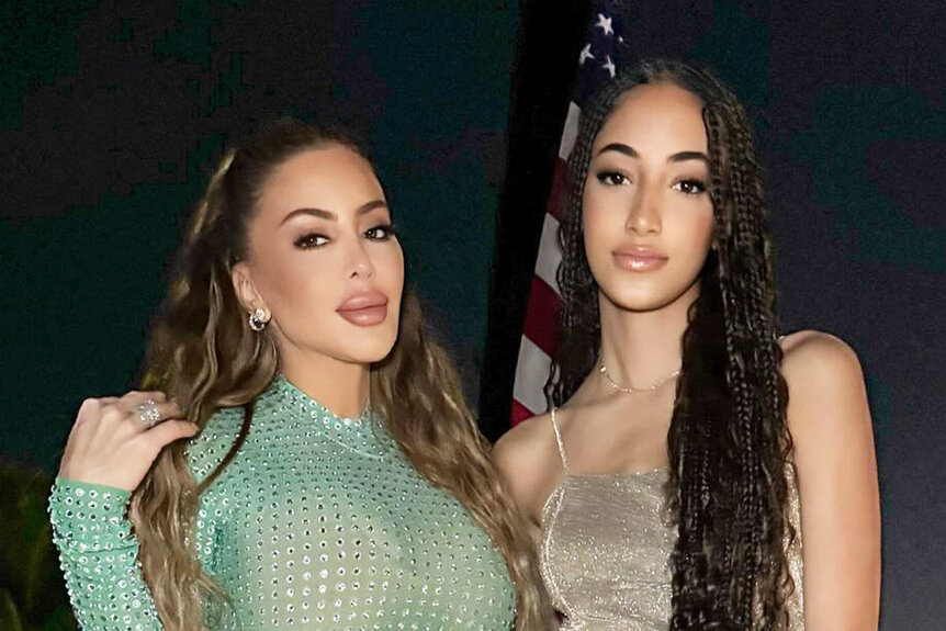 Larsa Pippen and Sophia Pippen posing together outdoors in cocktail attire.