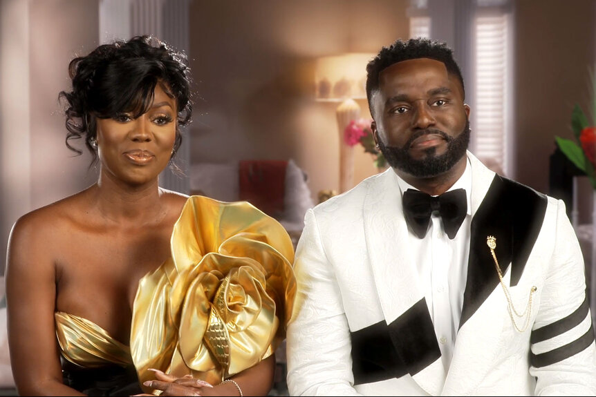 Wendy Osefo wearing a gown and Eddie Osefo wearing suit