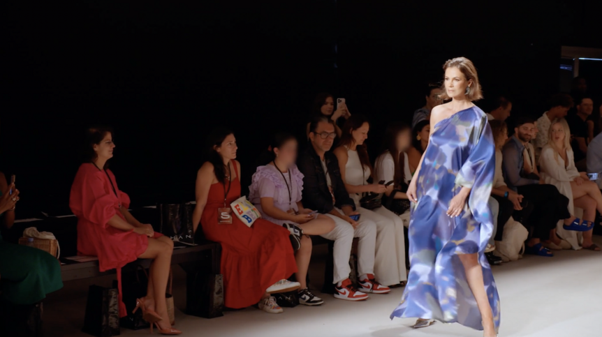 Julia Lemigova poses in long blue dress on a runway in The Real Housewives of Miami 612.