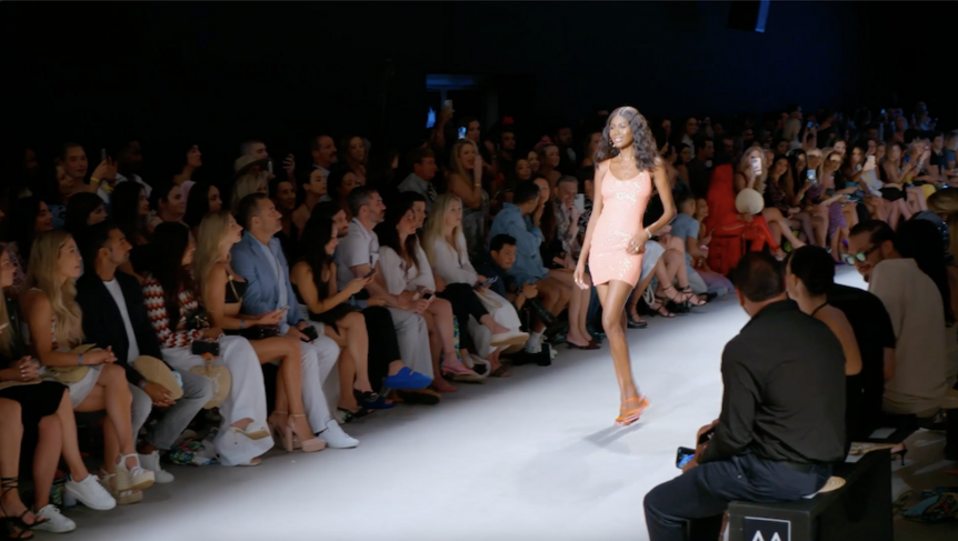 Kiki Barth poses in a sparkly peach dress on a runway in The Real Housewives of Miami 612.