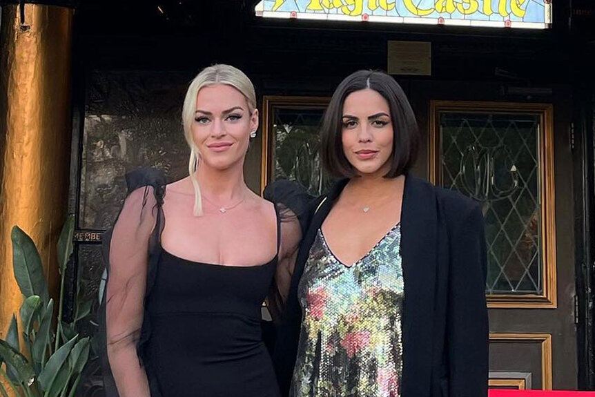 Katie Maloney and Dayna Kathan standing next to each other outside of the Magic Castle club.