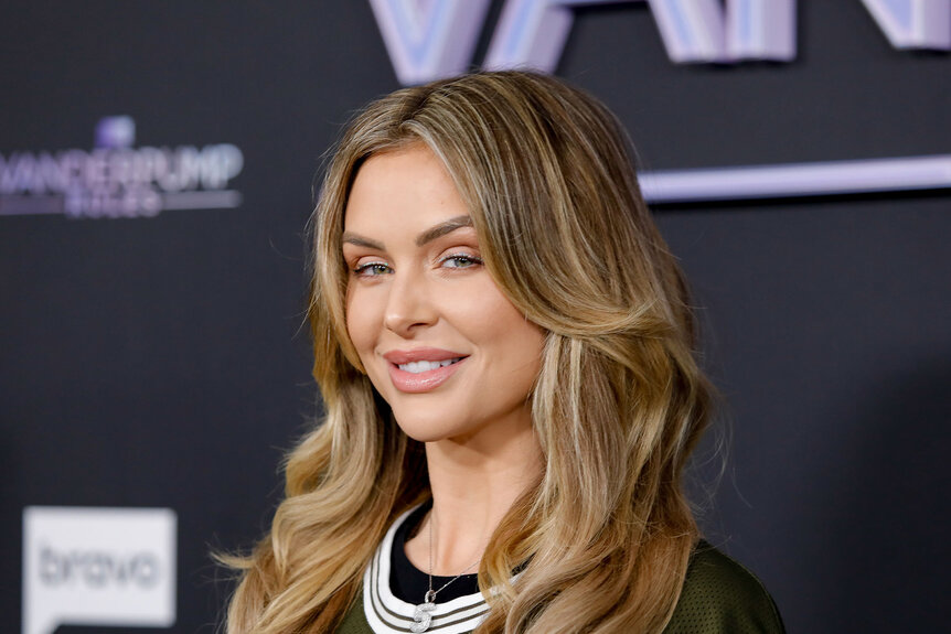 Lala Kent smiling in front of a step and repeat.