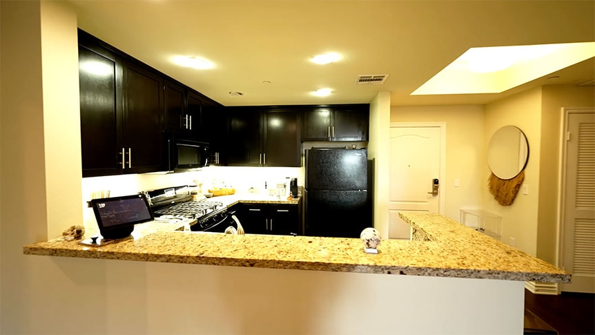 Kristen Doute's kitchen with black appliances and cabinetry.