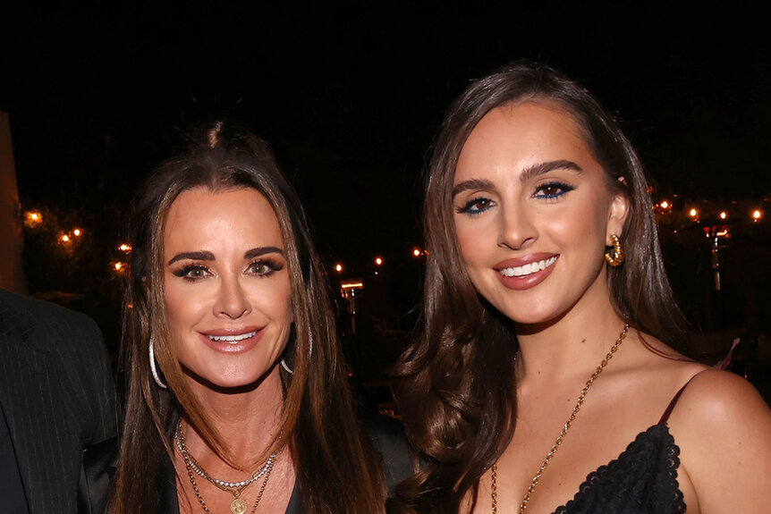 Kyle Richards and Alexia Umansky smiling next to each other at an event.