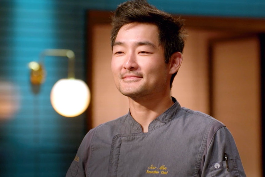 Chef Soo Ahn wearing a cooking apron in the Last Chance Kitchen