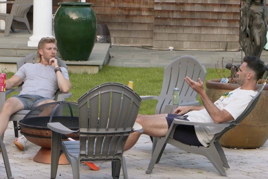 Kyle Cooke and Carl Radke lounge outside on pation furniture in Summer House Episode 804.
