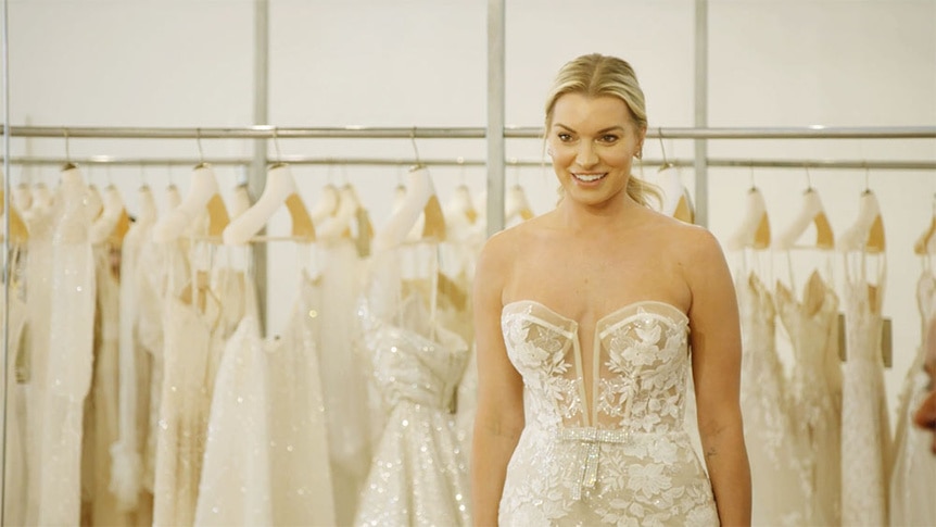 Lindsay Hubbard smiling in the mirror in her wedding dress.