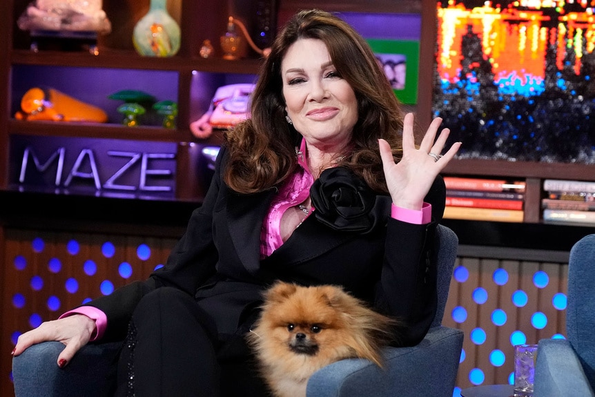Lisa Vanderpump waving with Donut at the Watch What Happens Live clubhouse in New York City.
