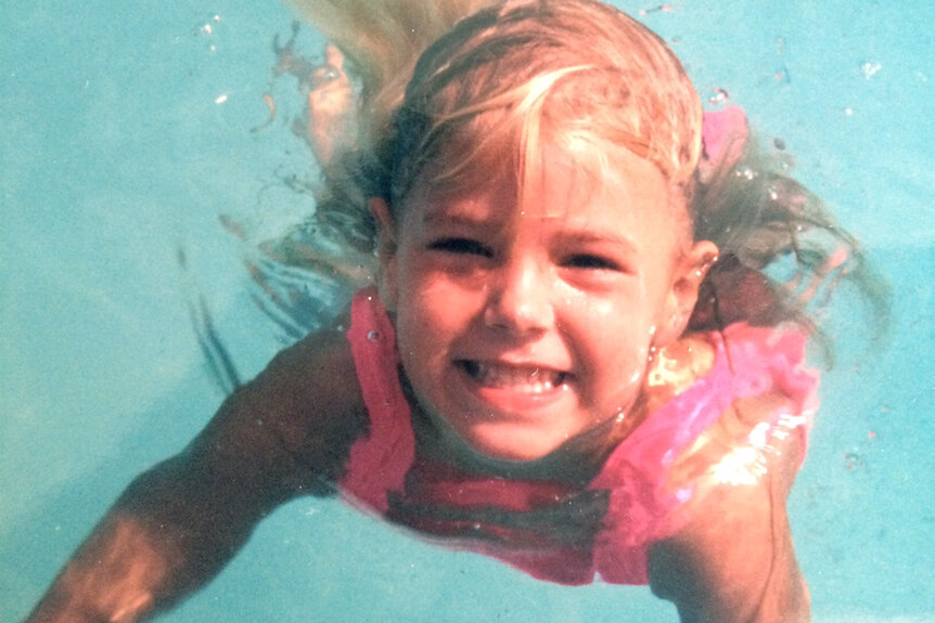 Ariana Madix swims in a pool as a child.