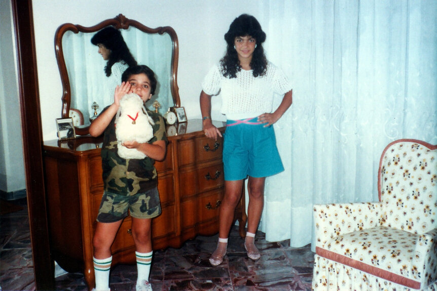 Joe Gorga and Teresa Giudice posing in a bedroom.
