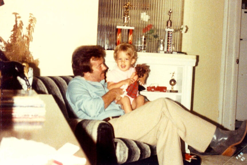 Lisa Hochstein being held by her father as a baby.