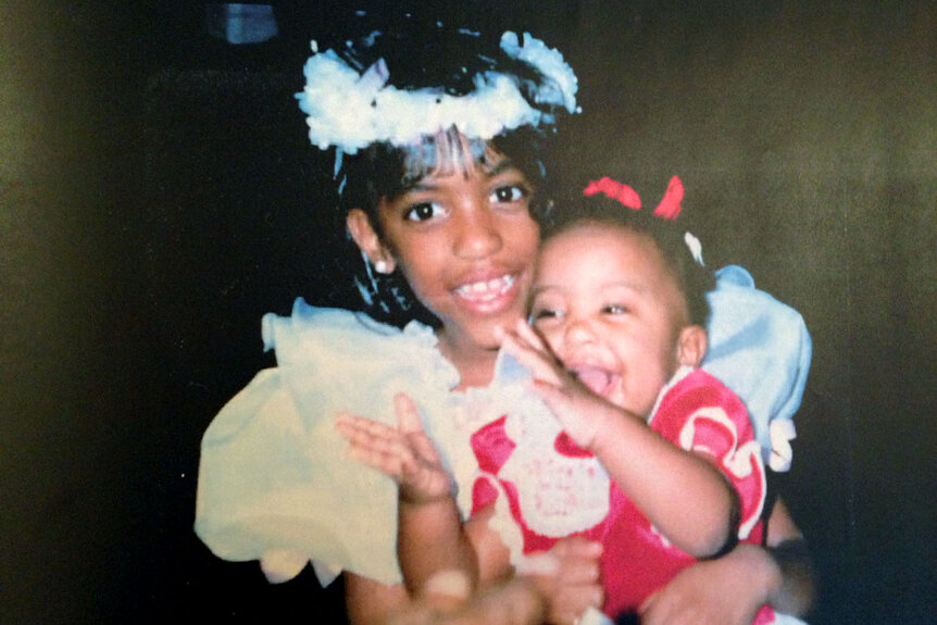Porsha Williams as a little girl wtih her sister, Lauren Williams, in her arms